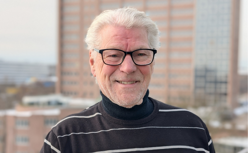 Älterer Herr mit schwarz weiß gestreiftem Pullover.